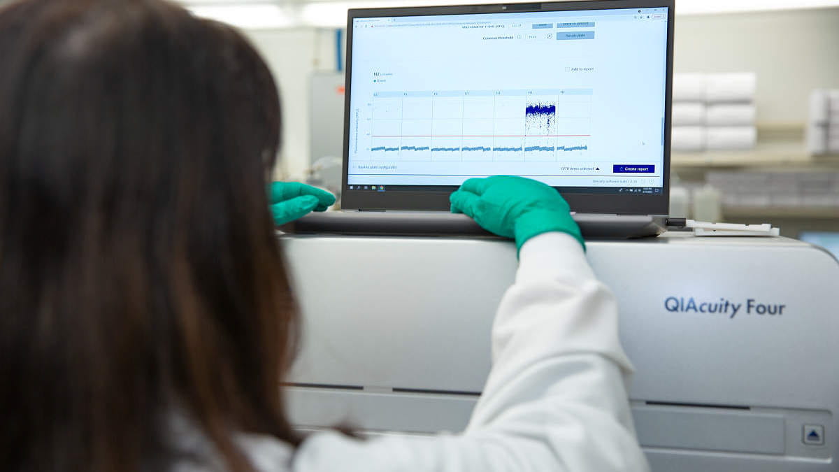 Scientist analyzing dPCR results on dPCR system